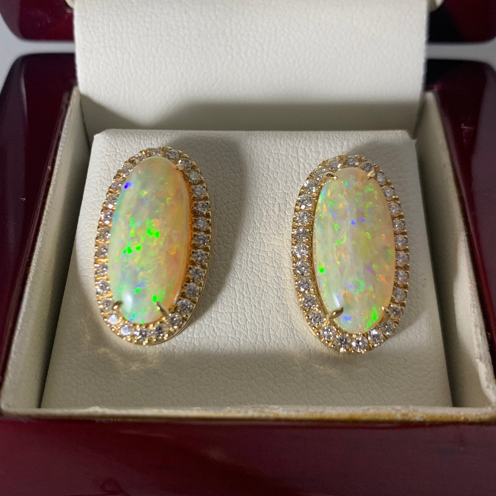A pair of 18-carat gold, opal, and diamond earrings