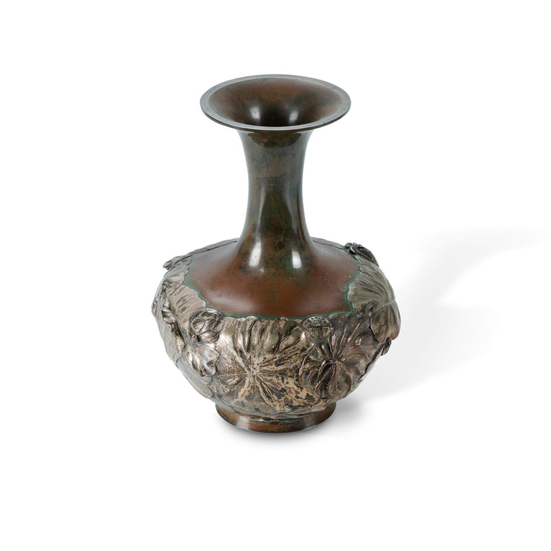 A Japanese mixed metal vase decorated with lotus plants in high relief.